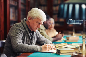 man writing research notes on Semax